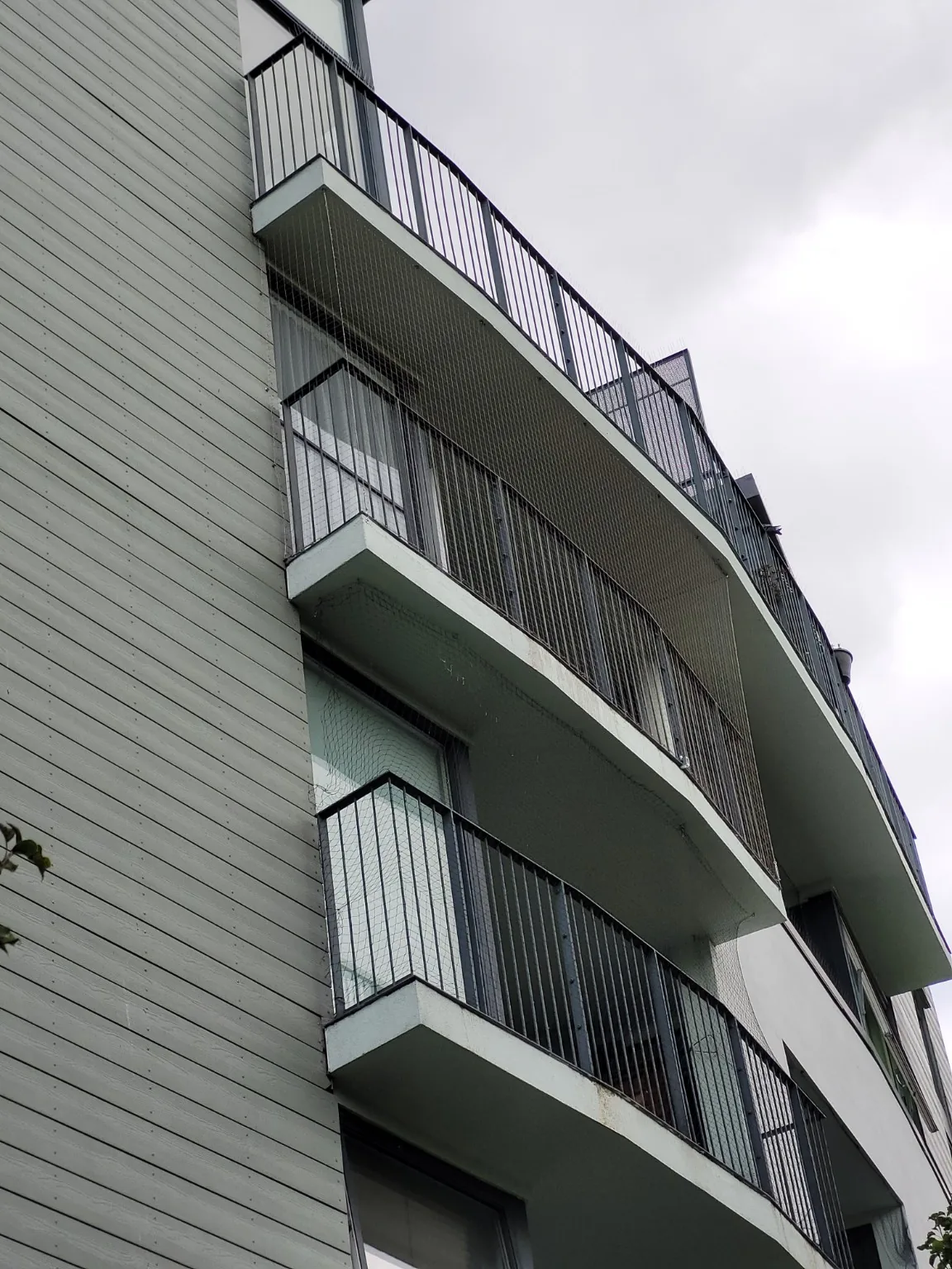 Balcony netting across multiple elevations